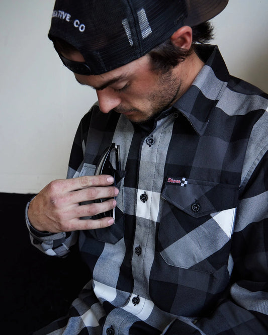 The Finish Line Flannel for Men.
Additional Info:
Men’s grey, white, and black plaid patterned flannel shirt
Machine wash cold with like colors
Hang to dry or tumble dry on low
Do not iron
Signature D-Tech™ polyester blend
Imported