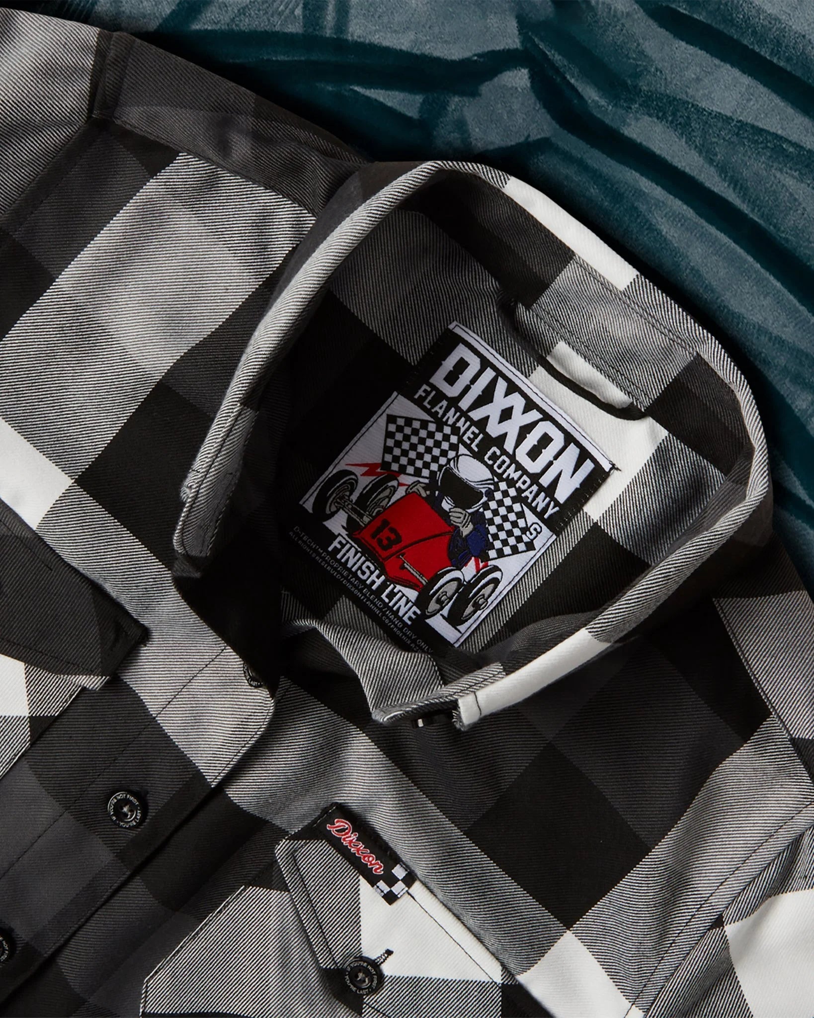 The Finish Line Flannel for Men.
Additional Info:
Men’s grey, white, and black plaid patterned flannel shirt
Machine wash cold with like colors
Hang to dry or tumble dry on low
Do not iron
Signature D-Tech™ polyester blend
Imported