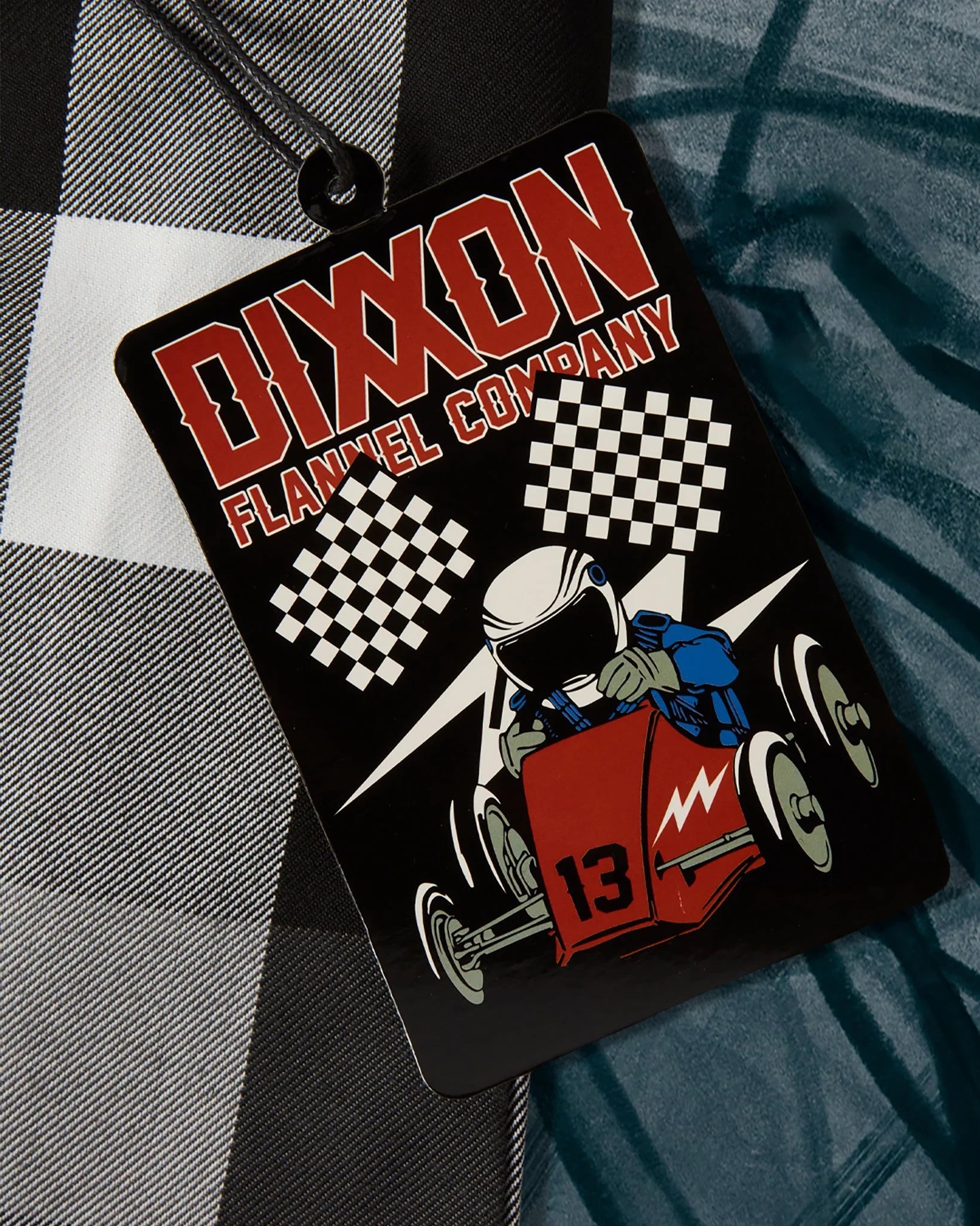 The Finish Line Flannel for Men.
Additional Info:
Men’s grey, white, and black plaid patterned flannel shirt
Machine wash cold with like colors
Hang to dry or tumble dry on low
Do not iron
Signature D-Tech™ polyester blend
Imported