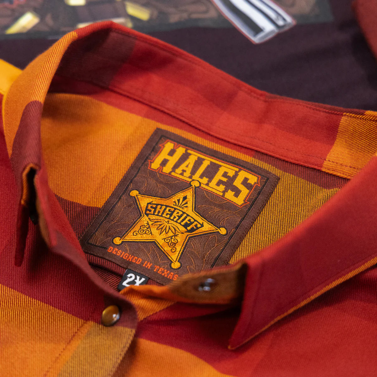 Worn by lawmen, cowboys, and outlaws alike, our "Sheriff" flannel guarantees a stylish and sharp look that will outlast your day! This long-sleeve pearl snap shirt features a timeless plaid pattern and the same unbeatable comfort of Hales Legendary Flannels that you already know and love. With a modern twist on a traditional western shirt, it boasts vibrant colors and our exclusive poly/spandex blend for ultimate comfort, making it an essential for any contemporary cowboy. The vibrant golden pearl snaps