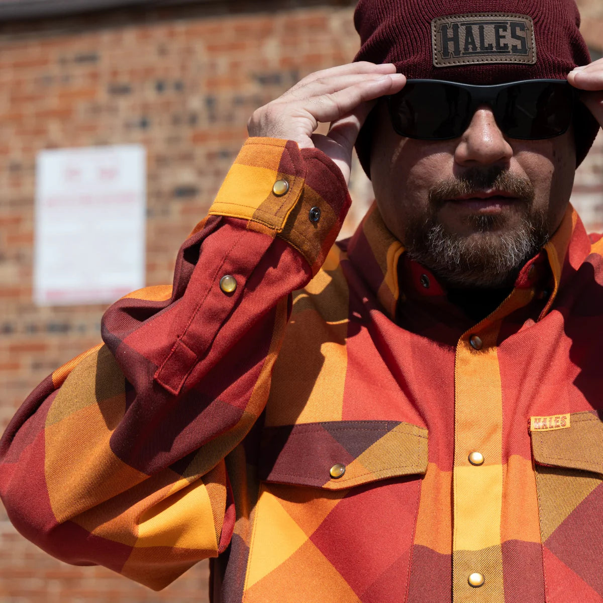 Worn by lawmen, cowboys, and outlaws alike, our "Sheriff" flannel guarantees a stylish and sharp look that will outlast your day! This long-sleeve pearl snap shirt features a timeless plaid pattern and the same unbeatable comfort of Hales Legendary Flannels that you already know and love. With a modern twist on a traditional western shirt, it boasts vibrant colors and our exclusive poly/spandex blend for ultimate comfort, making it an essential for any contemporary cowboy. The vibrant golden pearl snaps