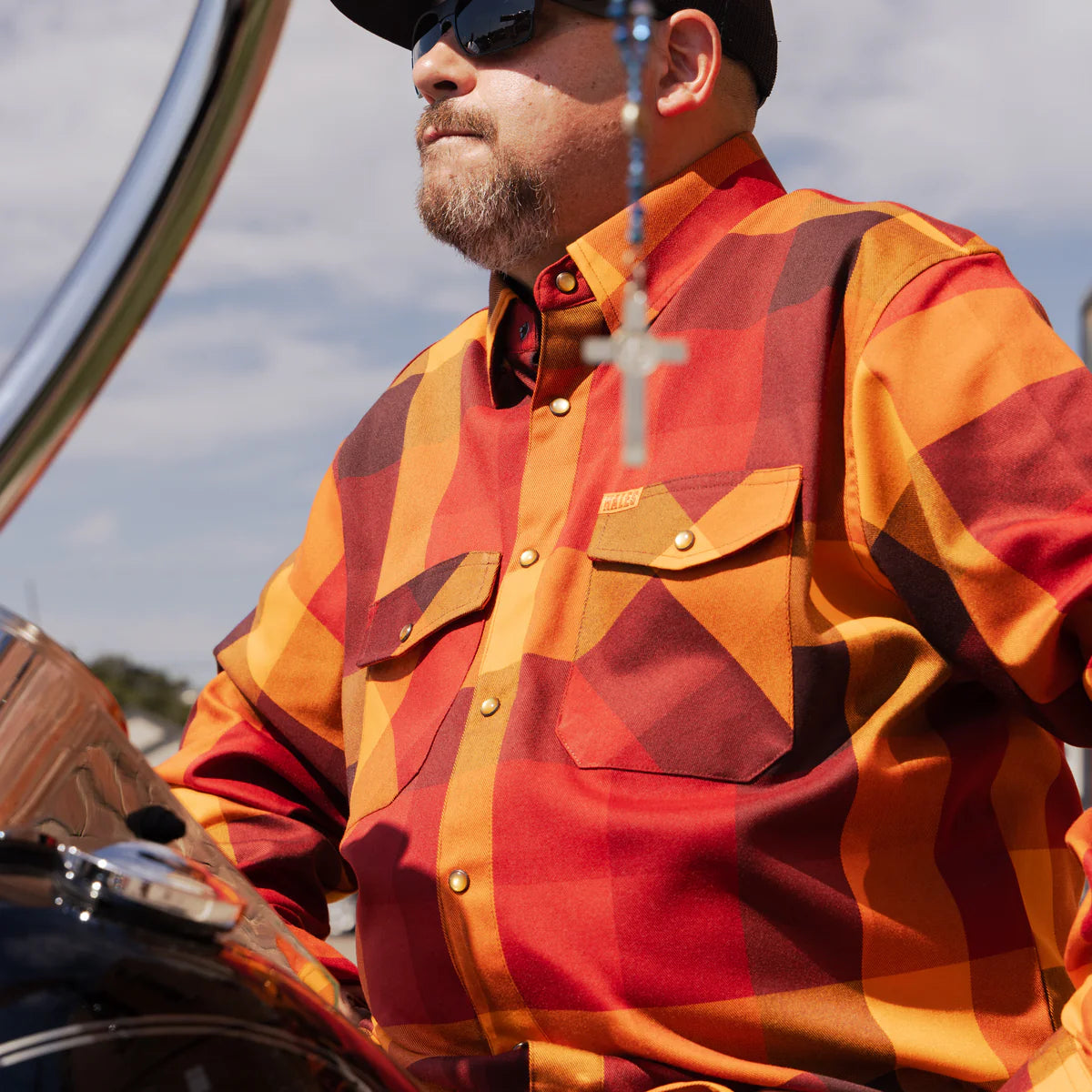 Worn by lawmen, cowboys, and outlaws alike, our "Sheriff" flannel guarantees a stylish and sharp look that will outlast your day! This long-sleeve pearl snap shirt features a timeless plaid pattern and the same unbeatable comfort of Hales Legendary Flannels that you already know and love. With a modern twist on a traditional western shirt, it boasts vibrant colors and our exclusive poly/spandex blend for ultimate comfort, making it an essential for any contemporary cowboy. The vibrant golden pearl snaps