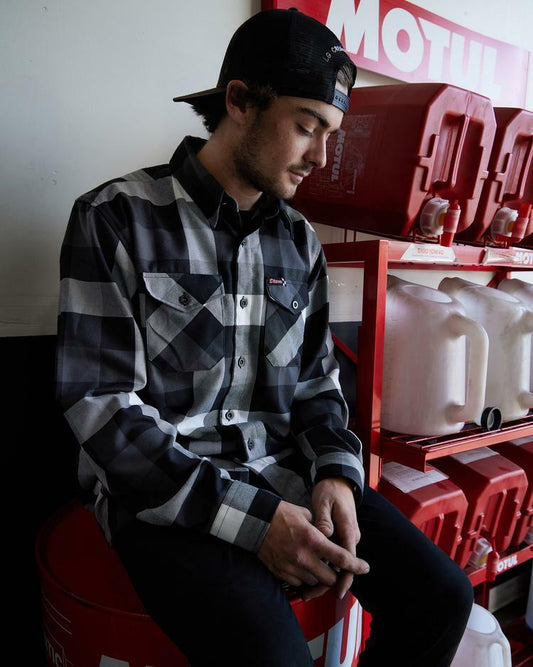 The Finish Line Flannel for Men.
Additional Info:
Men’s grey, white, and black plaid patterned flannel shirt
Machine wash cold with like colors
Hang to dry or tumble dry on low
Do not iron
Signature D-Tech™ polyester blend
Imported