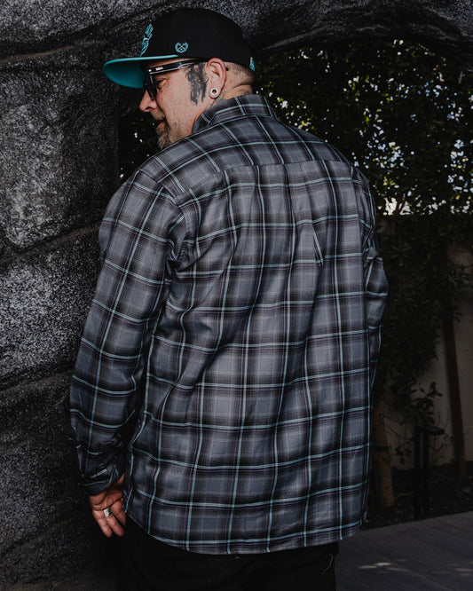 The FIFTH Flannel of the 6 Part Dancun Series, The Grotto Flannel features an allover black, gray, aqua blue, and purple plaid pattern that offers a clean and classic design, while our signature D-Tech™ blend provides the comfort of soft to the touch flannel. Constructed to be breathable for the performance you demand, yet durable for the rugged lifestyle you live.